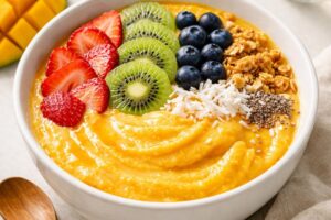 A colourful spread of mango smoothie bowls, coolers, desserts and fresh ripe mangoes celebrating National Mango Day